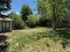 Spacious backyard with mature trees and a storage shed at 16180 E Flora Pl, Aurora, CO 80013