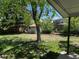 Enjoy the expansive backyard with mature trees and a convenient storage shed, seen from the patio at 16180 E Flora Pl, Aurora, CO 80013
