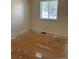 Bedroom with a window and hardwood floors that need finishing at 16180 E Flora Pl, Aurora, CO 80013
