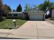 Charming single Gathering home with a well-manicured lawn and a two-car garage at 16180 E Flora Pl, Aurora, CO 80013