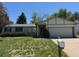Charming single Gathering home with a well-manicured lawn and a two-car garage at 16180 E Flora Pl, Aurora, CO 80013