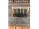 Close-up of brick fireplace with metal screen in living room for added safety and charm at 16180 E Flora Pl, Aurora, CO 80013