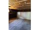 Open garage with shelving and a white garage door at 16180 E Flora Pl, Aurora, CO 80013