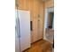 Kitchen space with light wood cabinets and modern white refrigerator at 16180 E Flora Pl, Aurora, CO 80013