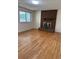 Cozy living room featuring hardwood floors and a brick fireplace for a warm and inviting atmosphere at 16180 E Flora Pl, Aurora, CO 80013