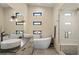 Bright bathroom featuring a soaking tub, dual sinks, and a walk-in shower at 1763 S Williams St, Denver, CO 80210