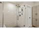 Modern bathroom featuring a glass enclosed shower with rainfall shower head and decorative tile wall at 1763 S Williams St, Denver, CO 80210