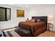 Well-lit bedroom with large bed, stylish furnishings, and a view to the backyard at 1763 S Williams St, Denver, CO 80210