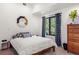 Bright bedroom featuring modern decor, stylish mirror, and a window with a view at 1763 S Williams St, Denver, CO 80210