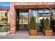 Exterior of a brick building at 1487, featuring a glass entrance, wooden planters, and a restaurant name at 1763 S Williams St, Denver, CO 80210