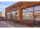 Exterior view of Kaladi Coffee Roasters, featuring large windows, a rusty metal facade, and outdoor seating at 1763 S Williams St, Denver, CO 80210