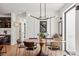 Formal dining room with a modern chandelier, and view into the stairwell at 1763 S Williams St, Denver, CO 80210