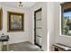 A well-lit foyer featuring modern decor, artwork and dark metal trimmed glass door at 1763 S Williams St, Denver, CO 80210