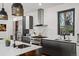 Well-appointed kitchen featuring an island with seating, range and a stainless steel vent hood at 1763 S Williams St, Denver, CO 80210