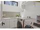 Well-lit laundry room with modern washer and dryer and ample counter space at 1763 S Williams St, Denver, CO 80210