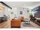 Open concept living room with stylish furniture, including leather sofa, and access to bar at 1763 S Williams St, Denver, CO 80210