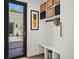 A mud room with storage lockers, coat hooks, and a bench by the exterior door at 1763 S Williams St, Denver, CO 80210