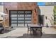 Stylish outdoor patio featuring modern dining furniture and a unique glass garage door at 1763 S Williams St, Denver, CO 80210
