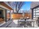 Relaxing patio area with modern outdoor furniture, grill, and partial cover near large sliding glass doors at 1763 S Williams St, Denver, CO 80210
