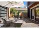 Secluded outdoor patio featuring an umbrella, modern furniture, a stone fire pit, and stylish design elements at 1763 S Williams St, Denver, CO 80210