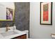 Modern powder room with designer wallpaper, stylish mirror, and contemporary fixtures at 1763 S Williams St, Denver, CO 80210
