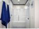 Walk-in shower with glass door and bench seating, tiled with modern accents at 1763 S Williams St, Denver, CO 80210