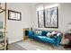 Stylish sitting room with plush blue velvet couch, bright window, and modern decor at 1763 S Williams St, Denver, CO 80210