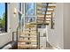 Modern staircase featuring wood treads, metal railings and abundant natural light at 1763 S Williams St, Denver, CO 80210