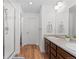 Bathroom with a large vanity, double sinks, and a walk-in shower at 17213 W 93Rd Pl, Arvada, CO 80007