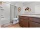 Functional bathroom boasts a shower-tub, toilet, vanity with sink, and decorative wall art at 17213 W 93Rd Pl, Arvada, CO 80007