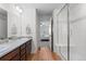 Bright bathroom with a double vanity, walk-in shower, and tile flooring at 17213 W 93Rd Pl, Arvada, CO 80007