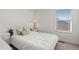 Bedroom featuring a bed, a bedside table and a window at 17213 W 93Rd Pl, Arvada, CO 80007