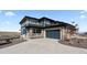 Beautiful two-story home featuring a stone facade, large driveway, and inviting front porch at 17213 W 93Rd Pl, Arvada, CO 80007