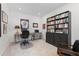 Home office with dual desks, a bookshelf and neutral carpeting at 17213 W 93Rd Pl, Arvada, CO 80007