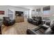 Cozy living room with a plush leather sofa and a large window view at 17213 W 93Rd Pl, Arvada, CO 80007
