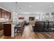 Open-concept living area features wood floors, recessed lighting, and comfortable seating at 17213 W 93Rd Pl, Arvada, CO 80007