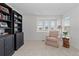 Cozy sitting area with natural light and built in bookshelves at 17213 W 93Rd Pl, Arvada, CO 80007