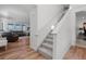 Open floor plan featuring staircase leading to a living room with plush leather seating at 17213 W 93Rd Pl, Arvada, CO 80007