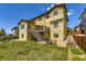 Beautiful backyard featuring a two-story home, a deck, a patio, and lush lawn at 14074 Yellow Tip Dr, Parker, CO 80134