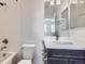 Bright bathroom featuring a white vanity, toilet, tub, and a shower with tiled walls at 14074 Yellow Tip Dr, Parker, CO 80134