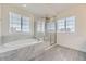 Spa-like bathroom featuring a soaking tub, separate shower, and tile floors at 14074 Yellow Tip Dr, Parker, CO 80134