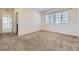 Spacious bedroom featuring neutral carpet, white walls, ample natural light, and an open layout at 14074 Yellow Tip Dr, Parker, CO 80134