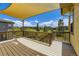 A backyard deck with covering offers great views of the surrounding lush green landscape at 14074 Yellow Tip Dr, Parker, CO 80134