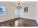 Formal dining room with hardwood floors, modern chandelier and natural light at 14074 Yellow Tip Dr, Parker, CO 80134