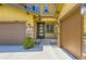 Inviting entryway showcasing a modern front door, sidelights, and two-car garage at 14074 Yellow Tip Dr, Parker, CO 80134