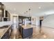 Well-equipped kitchen featuring dark wood cabinetry, granite countertops, stainless steel appliances, and a spacious center island at 14074 Yellow Tip Dr, Parker, CO 80134