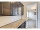 Charming kitchen featuring granite countertops and dark brown cabinets at 14074 Yellow Tip Dr, Parker, CO 80134