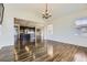 Spacious living room with hardwood floors that flow into an open-concept kitchen and dining area at 14074 Yellow Tip Dr, Parker, CO 80134