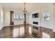 Bright living room featuring hardwood floors, a fireplace, a ceiling fan, and large windows for ample natural light at 14074 Yellow Tip Dr, Parker, CO 80134