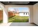 View of a well-maintained backyard featuring a manicured lawn and a wooden fence, as seen from a covered porch at 535 Albion St, Denver, CO 80220
